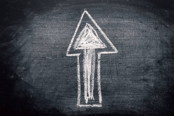 Arrow symbol, chalk on dirty blackboard. Concept of choosing the right direction in education.