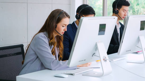 istock Business people wearing headset working in office 1268072276