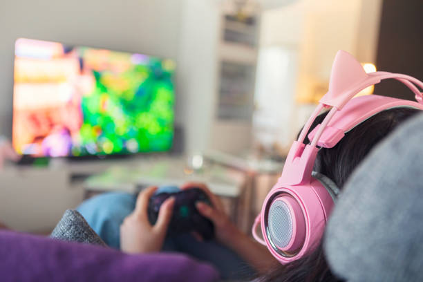 istock Girl playing a game on a video game console 1268072380