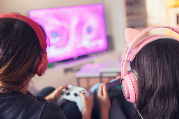 istock Mother and daughter playing together on a video game console 1268073215