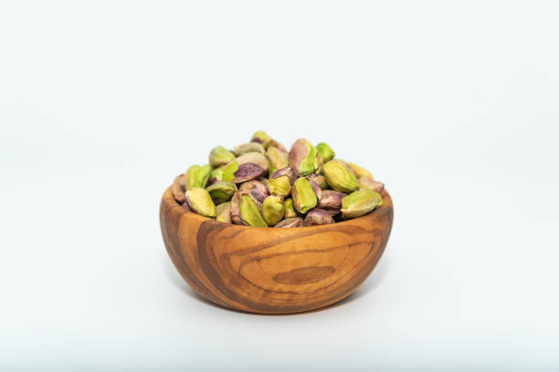 istock Pistachios nuts seed in a wooden bowl 1268073634