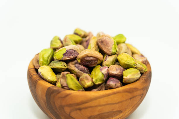 istock Pistachios nuts seed in a wooden bowl 1268073648