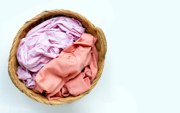 istock Clothes in laundry basket on white background. 1268074892
