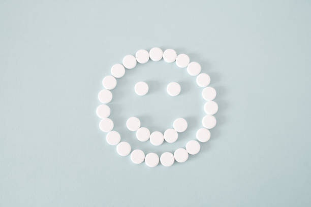 istock white pills positive smile on blue background 1268075701