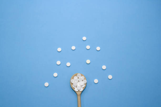 istock pills with wooden spoon 1268077354