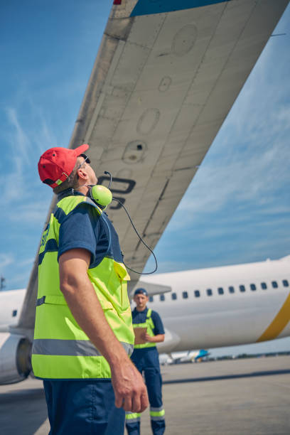 istock Engineers conducting a visual inspection of an airliner 1268078273