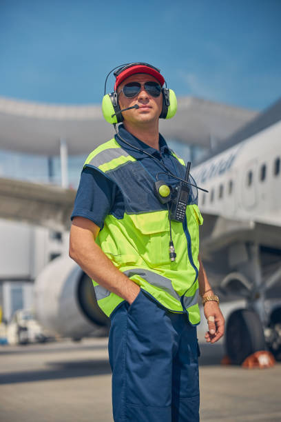 istock Male technician with a walkie-talkie looking forward 1268078291