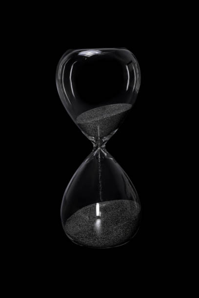 istock Hourglass isolated on black background 1268078557