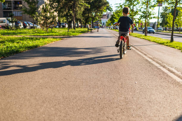 istock Boy riding a bike on a sunset 1268079025