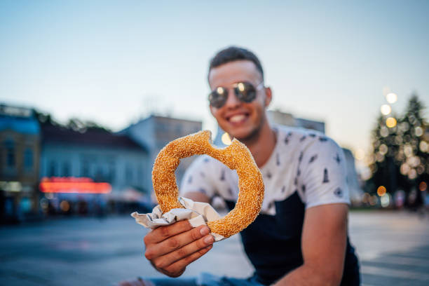 istock Young man holding a bagel 1268079674