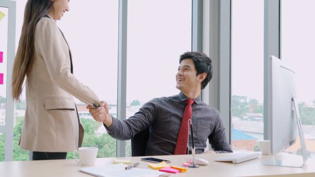 istock Two business people talk project strategy at office 1268079876