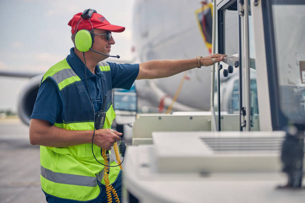 Airport worker standing in front of a pushback tug