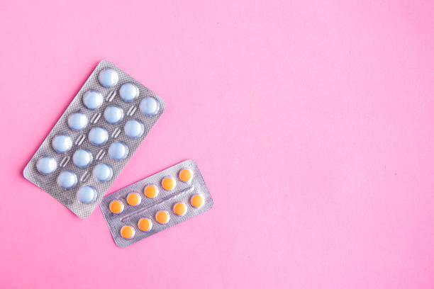 istock Medical pills on pink background, top view, copy space 1268083589