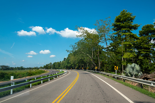 Two-lane highway in urban area is part of the road construction industry in olombia.