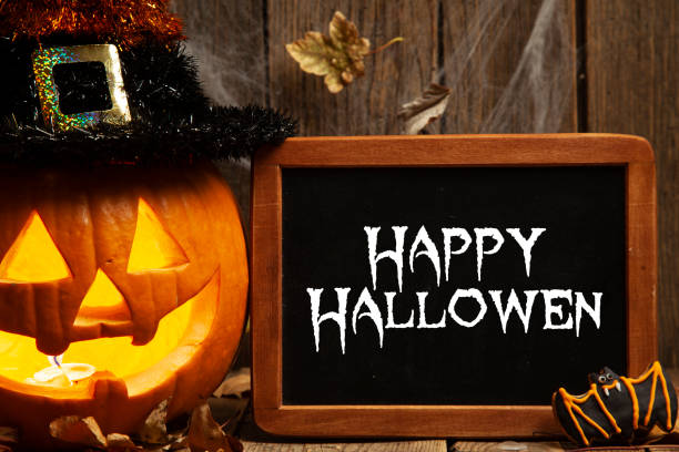 istock Halloween composition with chalkboard and gingerbread cookies on rustic wooden background 1268084336