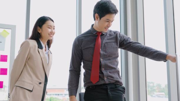 istock Two business people talk project strategy at office 1268084415