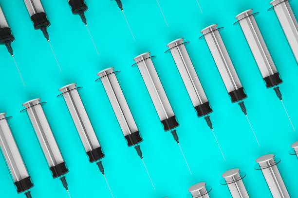 istock Pattern group of syringes lined up in a row on light blue 3D Illustration. 1268084575