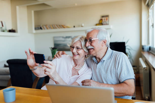 istock Cheerful senior couple taking a selfie 1268086667