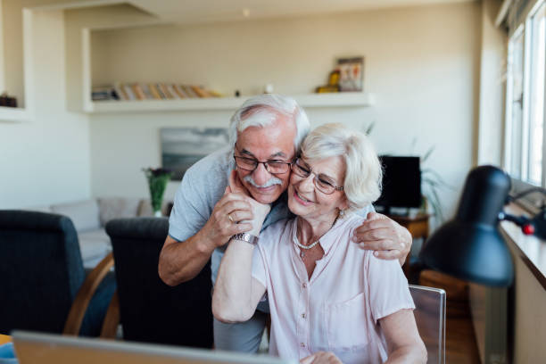 istock Happy elderly couple having a video call on a laptop 1268086747