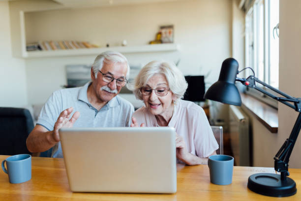 istock Happy elderly couple having a video call on a laptop 1268086770