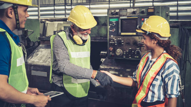 istock Group of factory workers using machine equipment in factory workshop 1268086773