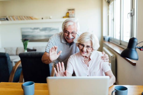 istock Happy elderly couple having a video call on a laptop 1268086774