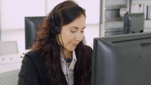 istock Business people wearing headset working in office 1268089640