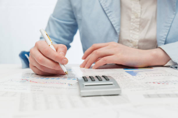 istock Financial accounting Business woman using calculator 1268099305