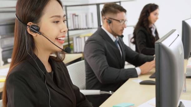 istock Business people wearing headset working in office 1268099475