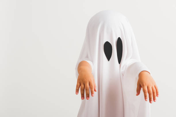 istock little cute child with white dressed costume halloween ghost scary 1268108611