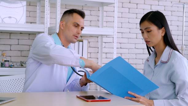 istock Doctor in professional uniform examining patient at hospital 1268112794