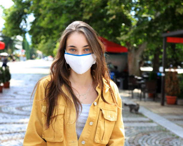 istock Young woman wearing face protective mask 1268120046