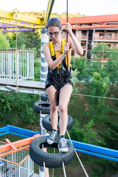 istock A young woman having fun on rope park - ropeway 1268120502