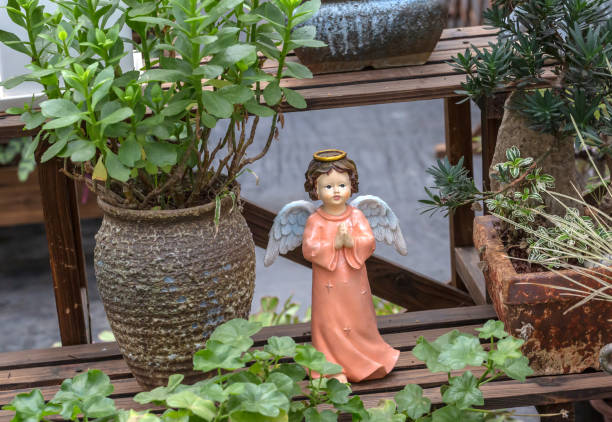 Fairy Statue in public garden with flower.
