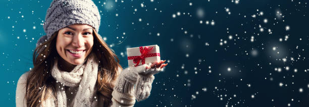 istock Young woman holding a Christmas gift 1268128552