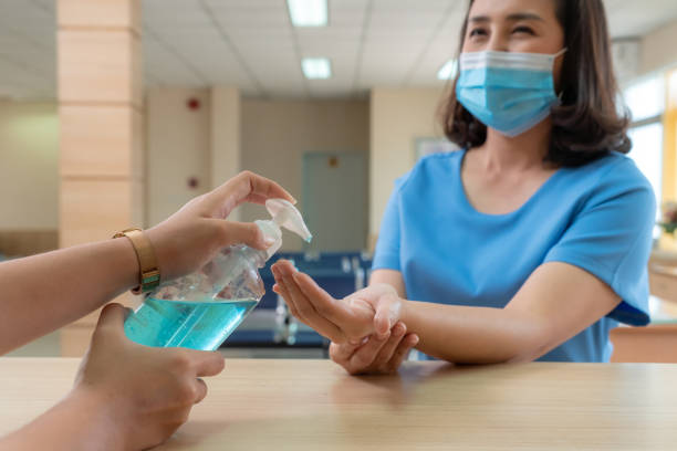istock Receptionist and guest wearing face mask at front desk . 1268128757