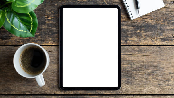 istock Mockup image tablet with blank white screen on wooden table 1268137333