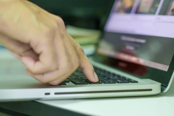 istock Single finger press on laptop keyboard, close up 1268137403