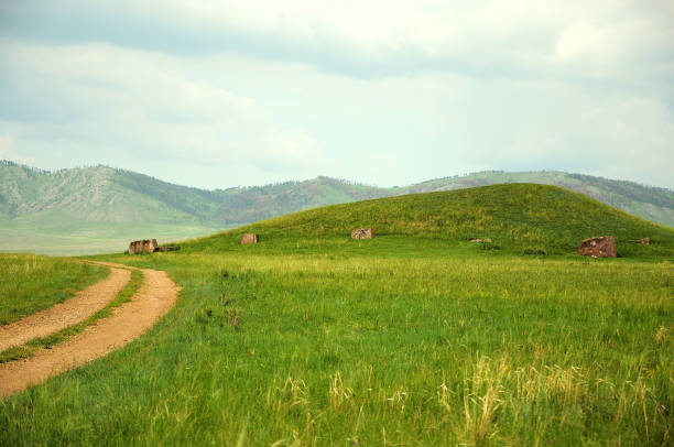The field road curving through the steppe and low hills.