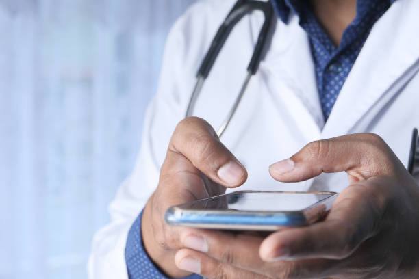 istock doctor in white coat using a smartphone. 1268142024