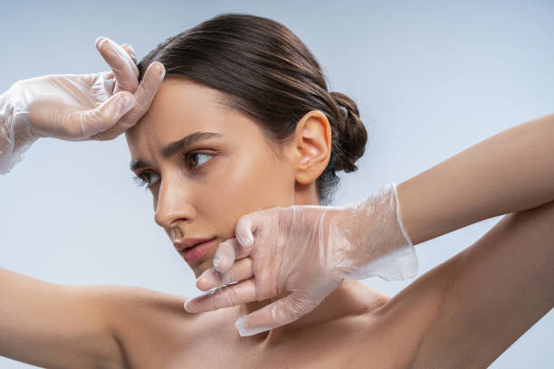 istock Sad female touching her face with gloved hands 1268148930