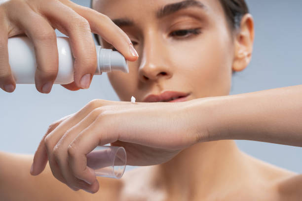 istock Female squeezing a small amount of cream from a pump bottle 1268148946