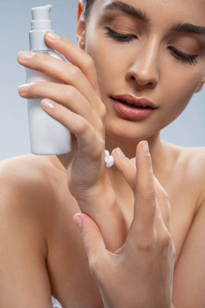 istock Concentrated pretty lady using a beauty product 1268148951