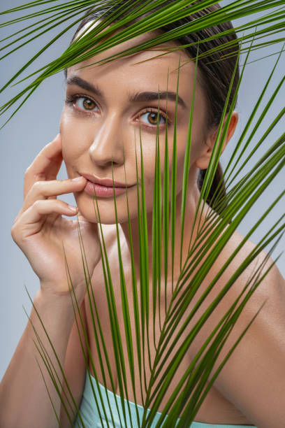 istock Tranquil pretty lady touching her well-groomed skin 1268148964