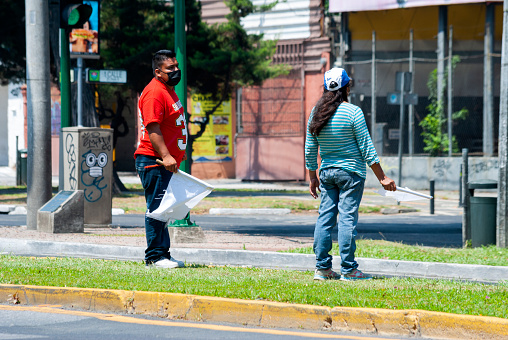 People requesting help in the streets of Guatemala City due to the COVID 19 pandemic, unemployed with white flags as a sign of poverty.