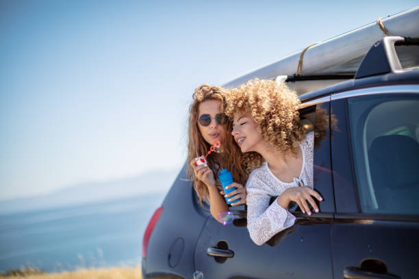 istock Friends having fun in car trunk 1268157176