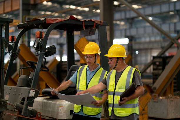 istock Two male factory administrators are communicating 1268159266