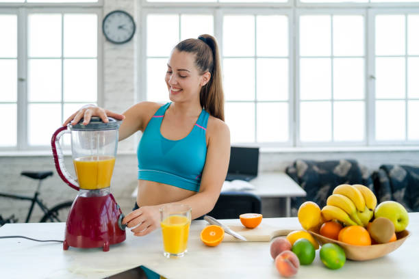 istock Young woman making detox smoothie at home 1268159378