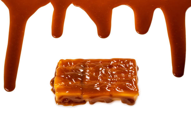 istock Background of flowing caramel sauce isolated on white. 1268163836