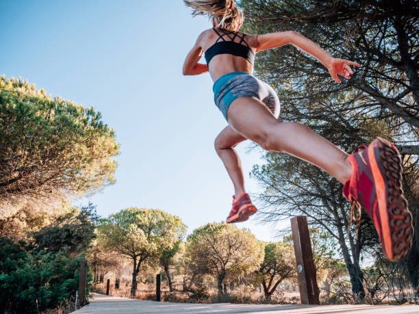 istock Low angle view of woman running in Summer 1268164417